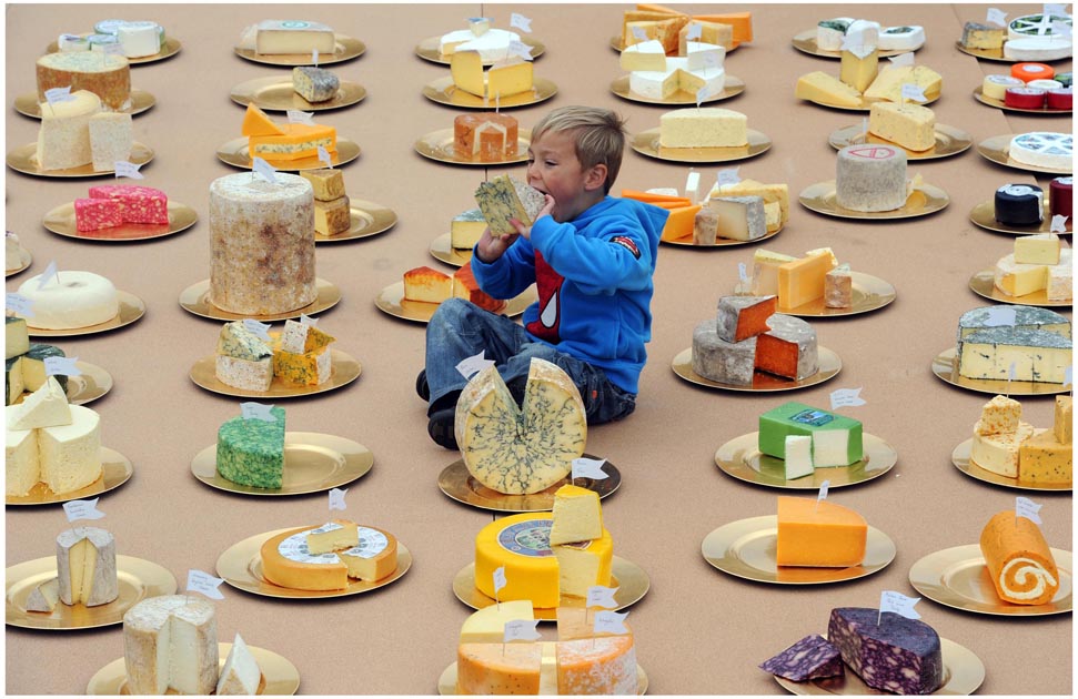 Four-year-old Aaron Ian Read takes a bite out of the Worlds Greatest Cheeseboard featuring over 150 different British cheeses. The cheeseboard has been created to show the variety and quality of British cheese as British Cheese Board research reveals the UK publics lack of knowledge about the cheese made on its doorstep. For further information please contact Ed Callow 020 7612 8860, Lucy Dormandy on 0207 612 8840 or email british.cheese@kindredagency.com.